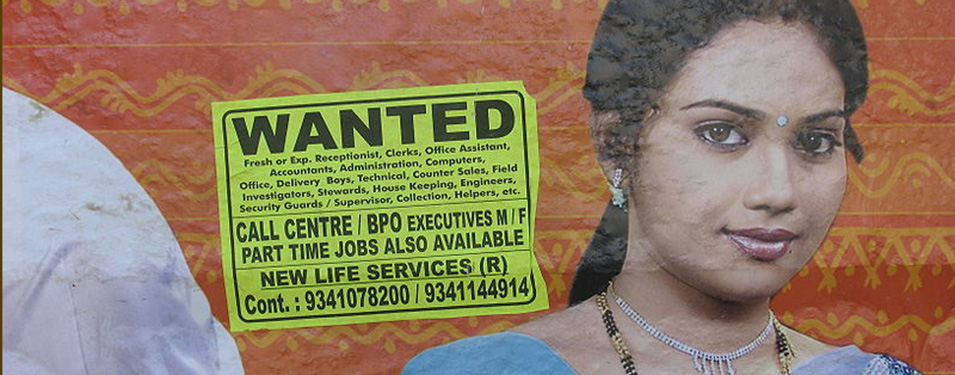Poster announcing employment opportunities in call centers and other business process outsourcing (BPO) operations on a wall next to the Shavij Nagar bus station in Bangalore. Image from Wikimedia commons.