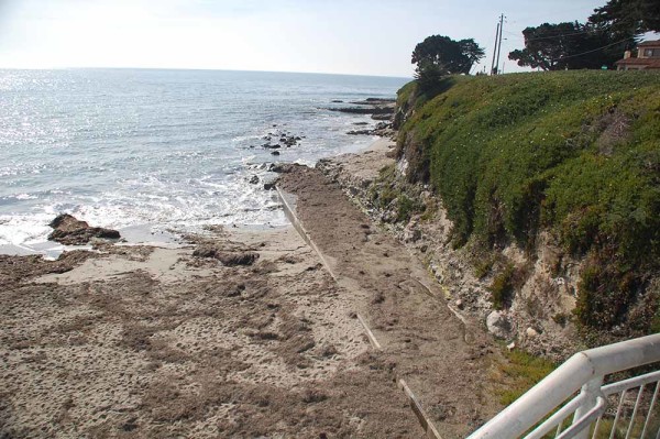 The disposal pipeline leaves the beach from the rectangular cement structure on the right (west) side of the beach.