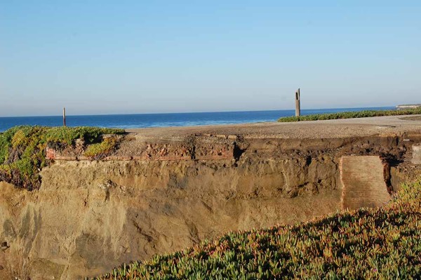 Brick remnants of the original 1869 lighthouse (center left). The round brick thing (center right) was a cistern used for collecting rainwater from the lighthouse roof.  These can be seen in the cliff edge in the cove to the east of the "Don't Be Next" sign.