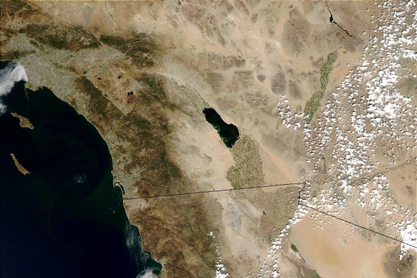 The Salton Sea with an algal bloom just starting on the fringes of the lake, May 28, 2003. This is part of a series of Moderate Resolution Imaging Spectroradiometer (MODIS) images showing the evolution of an algal bloom. Credit to: Jacques Descloitres, MODIS Rapid Response Team, NASA/GSFC.  