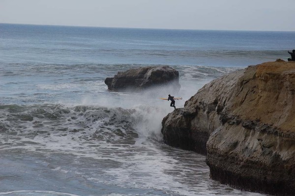 A surfer jumping into the waves from "The Point." Photo: Julia Gaudinski