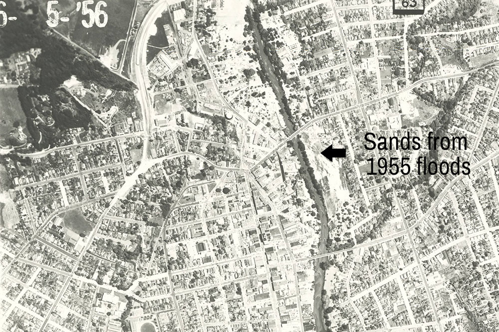 Aerial photo of downtown Santa Cruz, June 5, 1956. Black arrow points to the sands left behind by the San Lorenzo River in the 1955 floods and the present day location of San Lorenzo Park. Photo from the collection of Gary Griggs.