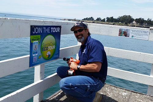 Dave Rosener installs a new Santa Cruz EcoTour sign on the wharf, April 2014.