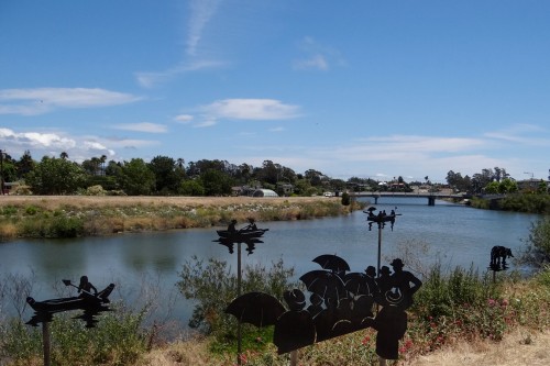 Installed along the riverbank, the River Ghost boats appear to be floating down the San Lorenzo River. Photo 2015, copyright Ron Holman.